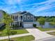 Charming two-story home features a balcony, well-manicured lawn, and waterfront views with a two car garage at 3149 Timberline Dr, Johns Island, SC 29455