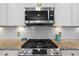 Modern gas range stove, stainless steel microwave, and white subway tile backsplash complete the kitchen at 3149 Timberline Dr, Johns Island, SC 29455