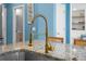 Close up of a gold kitchen faucet, stainless steel sink, and granite counter top at 3149 Timberline Dr, Johns Island, SC 29455