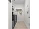 Bright laundry room with wood-look flooring, stainless steel washer and dryer and white walls at 3149 Timberline Dr, Johns Island, SC 29455