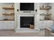 Elegant living room showcasing a fireplace, built-in cabinets, and shelving for storage and decor at 3149 Timberline Dr, Johns Island, SC 29455