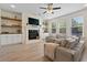 Bright living room featuring a fireplace, built-in shelving, and comfortable couches for a relaxing ambiance at 3149 Timberline Dr, Johns Island, SC 29455