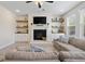 Inviting living room with a fireplace, shelving, and plush couches creating a cozy atmosphere at 3149 Timberline Dr, Johns Island, SC 29455