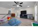 Spacious playroom with light hardwood floors, TV, and play kitchen area at 3149 Timberline Dr, Johns Island, SC 29455