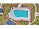 Aerial view of community pool surrounded by lounge chairs, umbrellas and landscaping at 317 Fiddleback Dr, Summerville, SC 29486