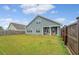 A spacious backyard showcasing the home's back exterior and covered patio at 317 Fiddleback Dr, Summerville, SC 29486