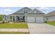 Charming home featuring stone accents, a covered porch, and a two-car garage in a well-manicured community at 317 Fiddleback Dr, Summerville, SC 29486