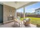 Inviting covered patio with a brick fireplace, ceiling fan, and outdoor seating at 317 Fiddleback Dr, Summerville, SC 29486