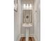 Stylish powder room with pedestal sink, decorative mirror, and modern lighting at 317 Fiddleback Dr, Summerville, SC 29486