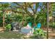 Backyard with a fire pit, pergola, Adirondack chairs, and lush greenery at 32 Heathwood Dr, Charleston, SC 29407