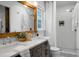 Beautiful bathroom featuring dual sinks, a framed mirror, and a tiled shower at 32 Heathwood Dr, Charleston, SC 29407