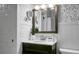 Bathroom features modern wallpaper, pedestal sink, and decorative mirror at 32 Heathwood Dr, Charleston, SC 29407