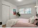 Bedroom featuring a decorative metal bed frame, large window, and spacious closet at 32 Heathwood Dr, Charleston, SC 29407