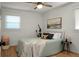 This bright bedroom has wood floors, a ceiling fan, and lots of natural light at 32 Heathwood Dr, Charleston, SC 29407