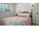 Cozy bedroom featuring a decorative metal bed frame, classic wall trim, and window at 32 Heathwood Dr, Charleston, SC 29407