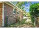 Brick home exterior featuring a fenced yard and mature landscaping at 32 Heathwood Dr, Charleston, SC 29407