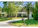 Beautiful brick home with a well-manicured lawn and a long driveway at 32 Heathwood Dr, Charleston, SC 29407