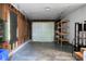 Spacious garage with shelves and a large door, offering plenty of storage and parking space at 32 Heathwood Dr, Charleston, SC 29407