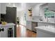 Well-lit kitchen featuring white cabinets, tiled floor, stainless steel appliances, and French doors at 32 Heathwood Dr, Charleston, SC 29407