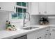 Close-up of a clean and modern kitchen sink with a bright window view at 32 Heathwood Dr, Charleston, SC 29407