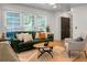 Cozy living room with a green sofa, textured rugs, and bright natural light at 32 Heathwood Dr, Charleston, SC 29407