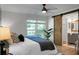 Bright main bedroom with a barn door to the en-suite bathroom and large windows at 32 Heathwood Dr, Charleston, SC 29407