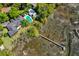 Aerial view of home with pool, lush greenery, and private dock extending into the tranquil waterway at 333 W Confederate Cir, Charleston, SC 29407