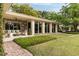 Spacious back patio with stylish seating, lush greenery, and a well-manicured lawn, perfect for outdoor living and entertaining at 333 W Confederate Cir, Charleston, SC 29407