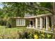 Lush backyard featuring a brick home with ivy, a manicured lawn, and a stone pathway leading to the home's entrance at 333 W Confederate Cir, Charleston, SC 29407