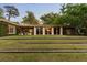 Beautiful backyard with a well-maintained lawn and terraced brick steps, seamlessly blending nature with the home's architectural design at 333 W Confederate Cir, Charleston, SC 29407