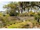 Exterior shot displaying well-manicured lawn with wooden walkway leading to private boat dock at 333 W Confederate Cir, Charleston, SC 29407