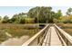 Exterior shot displaying wooden walkway leading to private boat dock with boat lift at 333 W Confederate Cir, Charleston, SC 29407