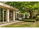 Serene backyard with a manicured lawn, mature trees, and a charming patio area, creating an ideal space for outdoor relaxation at 333 W Confederate Cir, Charleston, SC 29407
