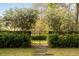 Brick path and iron gate leading to a serene and private backyard area at 333 W Confederate Cir, Charleston, SC 29407