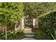 Landscaped backyard entrance featuring a brick wall, iron gate, and stepping stone path at 333 W Confederate Cir, Charleston, SC 29407