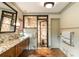 Bright bathroom with marble accents, wooden vanity, herringbone floors, and modern fixtures at 333 W Confederate Cir, Charleston, SC 29407