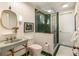 A charming bathroom is accentuated by a white and green color scheme with a glass walk-in shower at 333 W Confederate Cir, Charleston, SC 29407