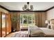 Inviting bedroom with natural light, hardwood floors, neutral tones, and a view of the outdoor landscape at 333 W Confederate Cir, Charleston, SC 29407