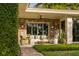 Charming covered patio with brick floor, stylish furniture, and lush landscaping at 333 W Confederate Cir, Charleston, SC 29407