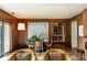 Charming dining area with wood paneled walls and adjacent access to a full bookshelf at 333 W Confederate Cir, Charleston, SC 29407