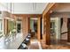Open-concept dining area features wood paneling, herringbone floors, and views of the outdoor patio at 333 W Confederate Cir, Charleston, SC 29407