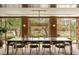 Elegant dining room with long wood table and chairs offering scenic outdoor views through large windows at 333 W Confederate Cir, Charleston, SC 29407