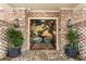 Brick entryway with potted plants lead into foyer showcasing scenic mural, table, lamp, and decorative rug at 333 W Confederate Cir, Charleston, SC 29407