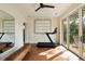 An exercise room boasts a treadmill, french doors, and a large mirror at 333 W Confederate Cir, Charleston, SC 29407