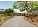 Charming single-story brick home with manicured landscaping, a circular driveway and mature trees at 333 W Confederate Cir, Charleston, SC 29407