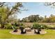Backyard firepit area with comfortable seating, offering a cozy and scenic spot to relax and enjoy the natural surroundings at 333 W Confederate Cir, Charleston, SC 29407