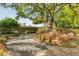 Charming single-story home with brick facade, mature trees, and professionally landscaped yard at 333 W Confederate Cir, Charleston, SC 29407