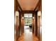 Elegant hallway with wood paneling, herringbone floors, decorative lighting, and a view to a bedroom at 333 W Confederate Cir, Charleston, SC 29407