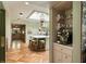 View of the kitchen island with seating, designer lighting, and doorway to the kitchen at 333 W Confederate Cir, Charleston, SC 29407