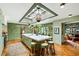 Bright, eat-in kitchen with green tile backsplash, skylight, large island with marble countertop and counter seating at 333 W Confederate Cir, Charleston, SC 29407